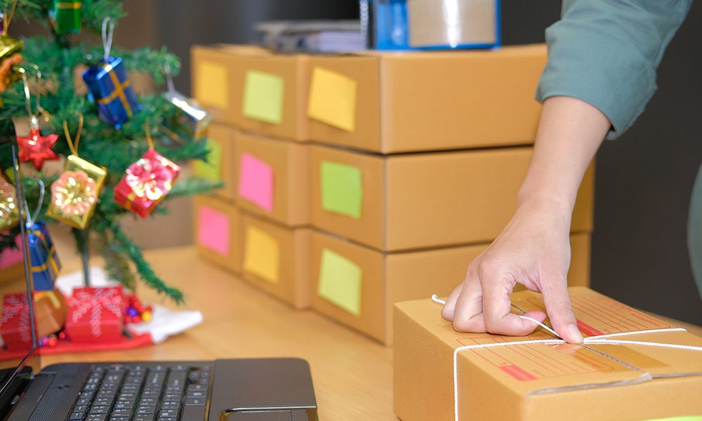 startup small business owner packing cardboard box at workplace. freelance man entrepreneur seller prepare product parcel box for deliver to customer. Online selling, e-commerce concept